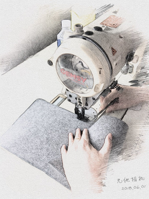 A Pisces Creation maker stitching laptop sleeve material on an industrial sewing machine